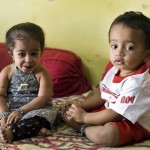 Jyoti with a family friend two years ago - who, at 13 months, is already bigger than she is